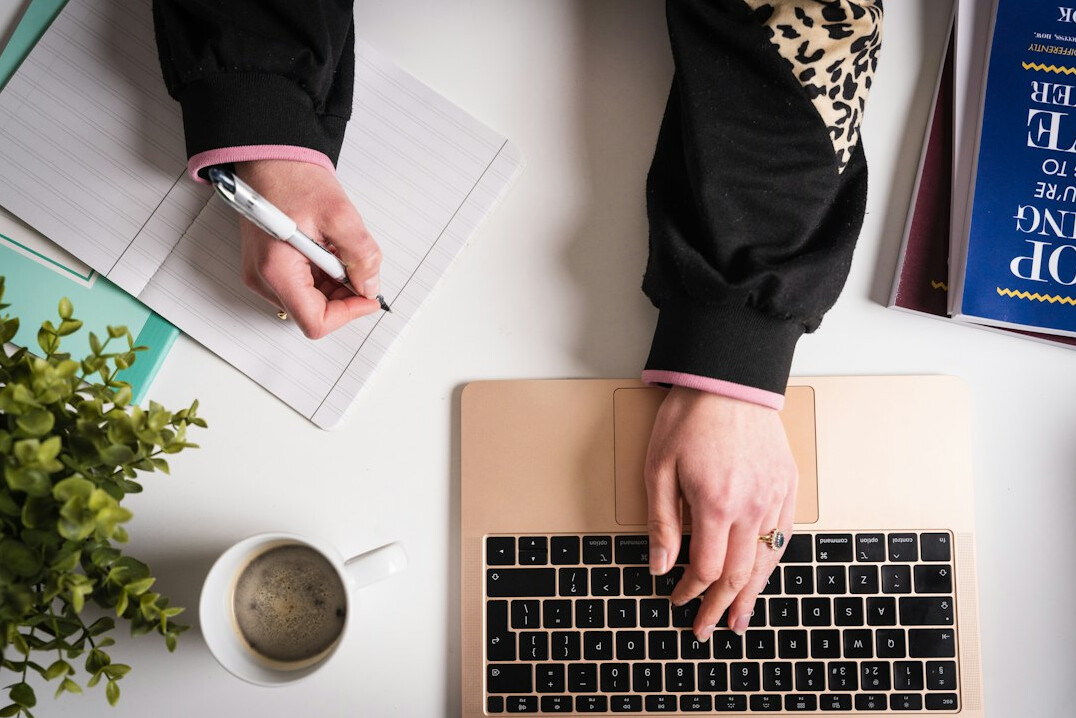 writer typing on laptop