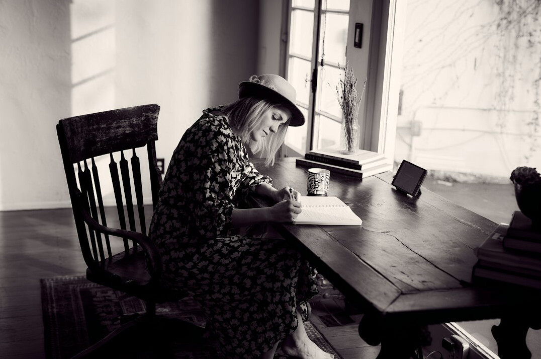 author editing manuscript at desk