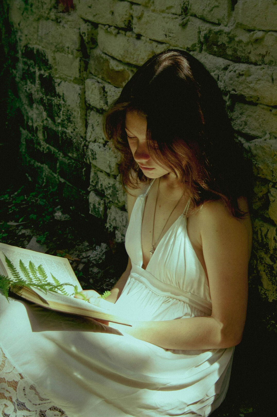 woman reading book at night